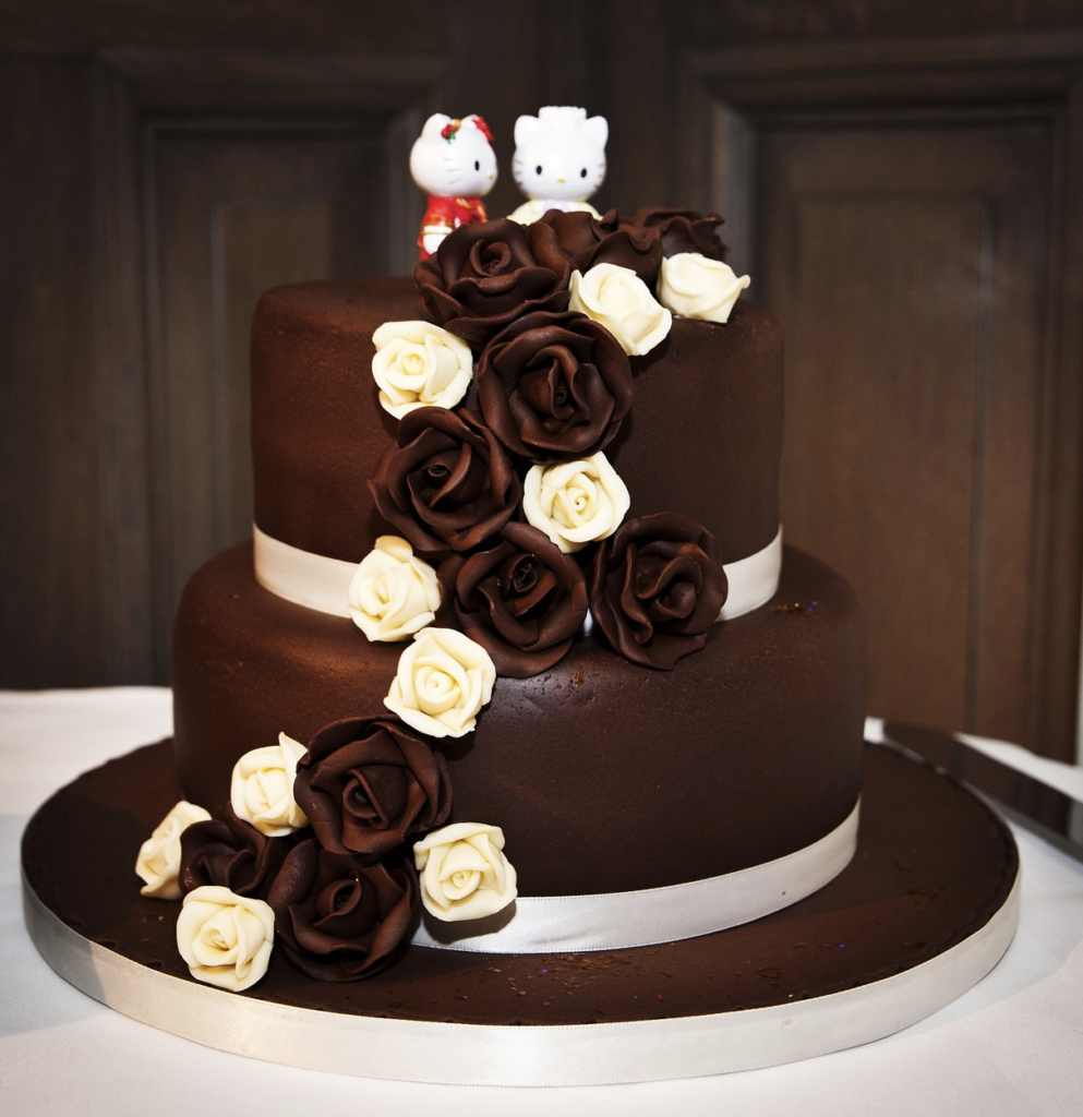 3 layer chocolate wedding cake with couple hello kitty character on the top