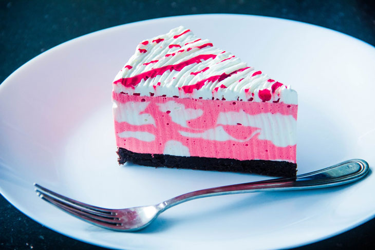sliced white and pink icing covered cake